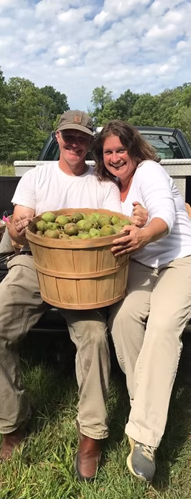 The farmer of Stillwater Valley Orchard & Apiary among the trees
